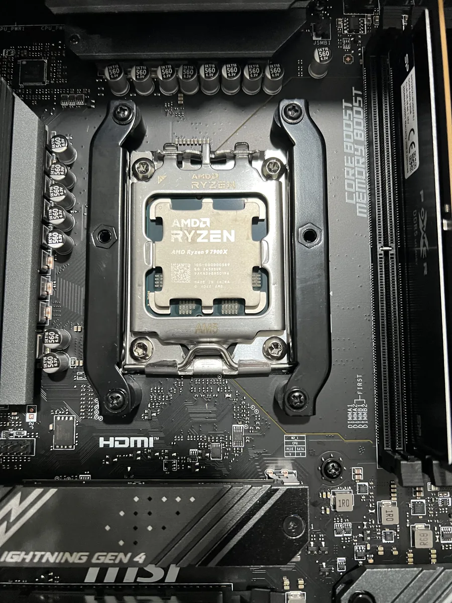 Ryzen 9 7900X seated in the motherboard socket