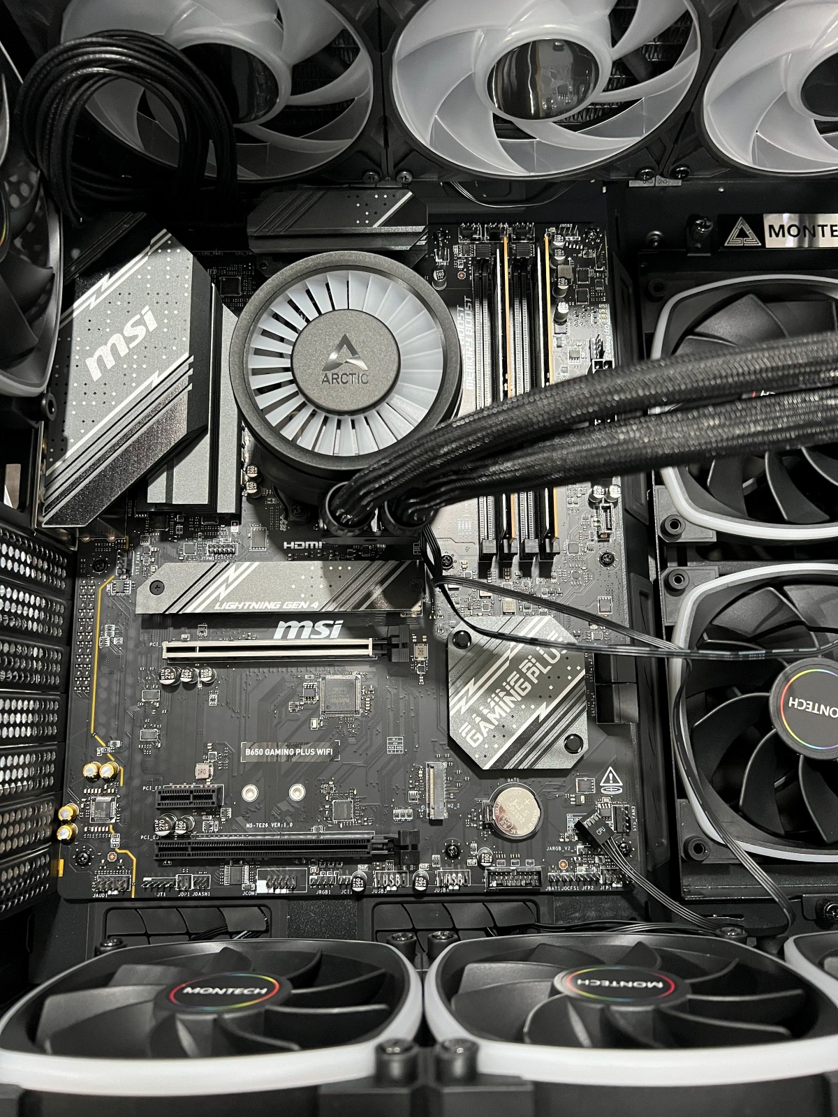 The 360 mm liquid cooler and front intake, installed and cabled before first power-on.